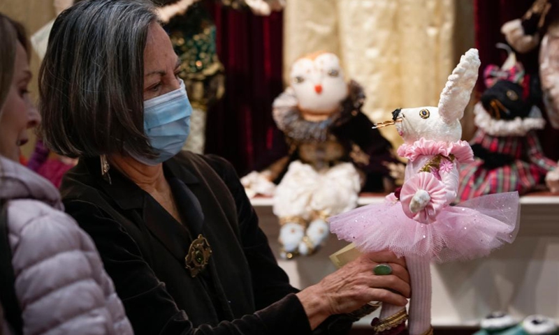 People look at a handmade doll at the Circle Craft Christmas Market in Vancouver, British Columbia, Canada, on Nov. 9, 2022.(Photo: Xinhua)