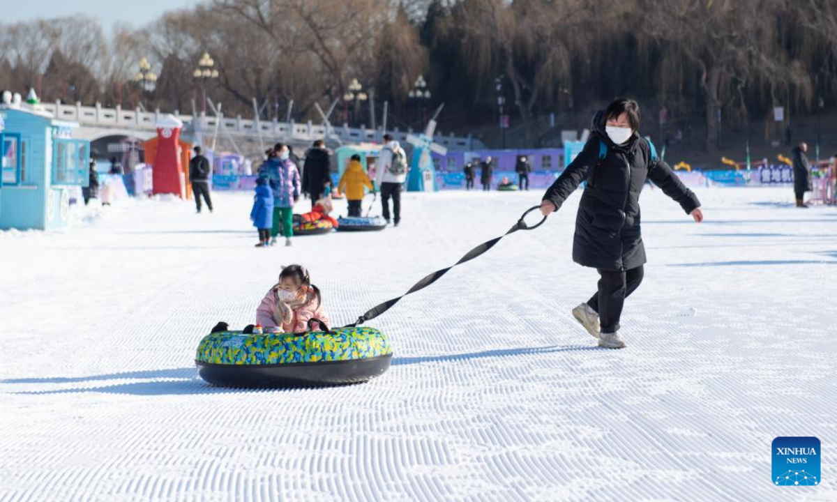 A mother plays with her child at an ice and snow carnival at Taoranting park in Beijing, capital of China, Dec 28, 2022. Photo:Xinhua