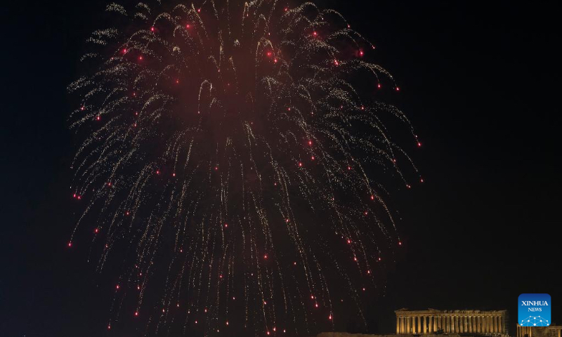 Fireworks explode by the Acropolis during the New Year celebrations in Athens, Greece, Jan. 1, 2023. (Xinhua/Marios Lolos)