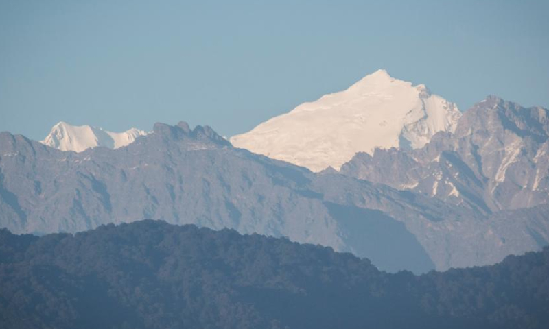 A mountain range is seen from the Kathmandu Valley during the sunset time on the occasion of the International Mountain Day in Lalitpur, Nepal, Dec. 11, 2022. (Photo by Hari Maharjan/Xinhua)