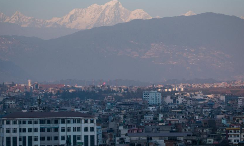 A mountain range is seen from the Kathmandu Valley during the sunset time on the occasion of the International Mountain Day in Lalitpur, Nepal, Dec. 11, 2022. (Photo by Hari Maharjan/Xinhua)