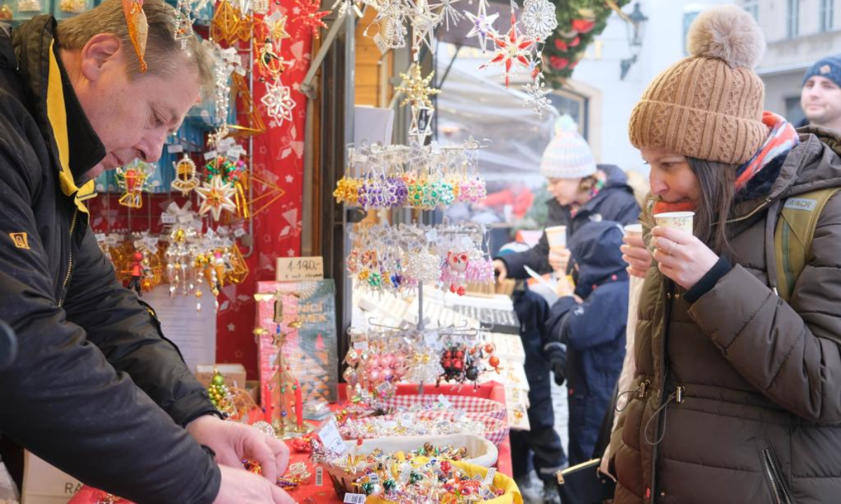 People visit a Christmas market at the Old Town Square in Prague, Czech Republic, Dec 16, 2022. TO GO WITH 