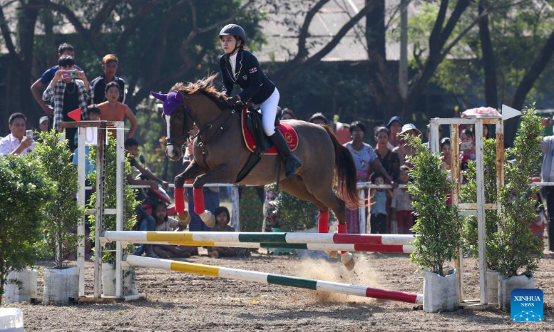 A jockey rides her horse during a horse racing competition in Yangon, Myanmar, Jan. 3, 2023. (Photo by Myo Kyaw Soe/Xinhua)