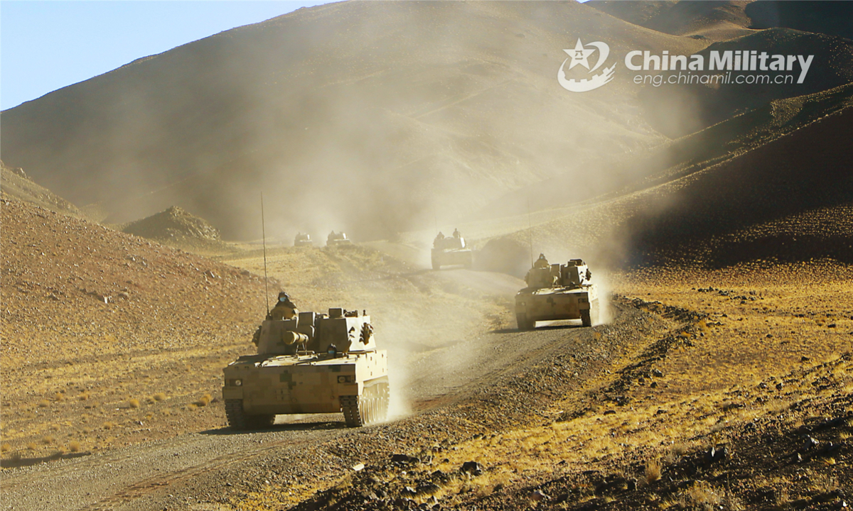 Armored vehicles attached to an artillery element of a combined-arms brigade under the PLA 77th Group Army rumble towards designated area during a field maneuver training exercise in mid-December. (eng.chinamil.com.cn/Photo by Tian Yudong)