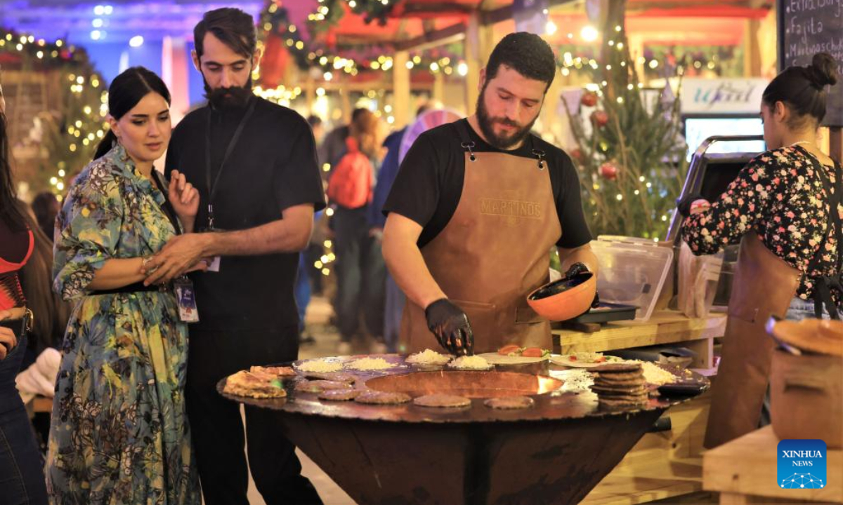 A man prepares food at a Christmas market in Beirut, Lebanon, on Dec 23, 2022. Photo:Xinhua