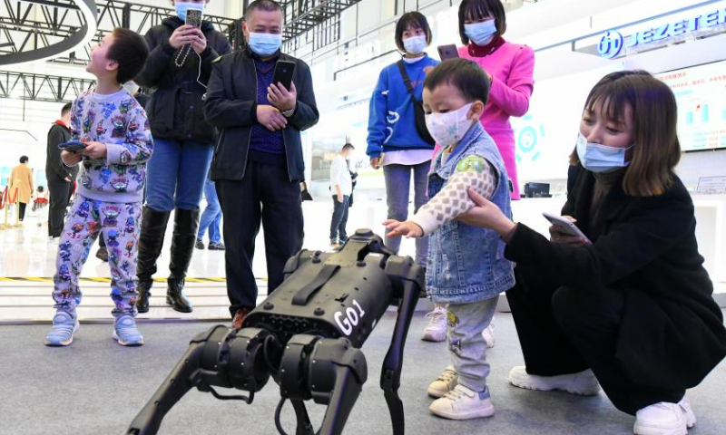 A child interacts with a robotic dog at the 10th China (Mianyang) Science and Technology City International High-Tech Expo in Mianyang, southwest China's Sichuan Province, Nov. 16, 2022. Photo: Xinhua