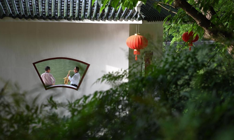 A citizen plays the instrument at Huancheng park in Hefei City, east China's Anhui Province, May 5, 2021.

Hefei has five national wetland parks and three provincial wetland parks, with a wetland protection rate of 75 percent.

It was accredited on Nov. 10, 2022 by the Ramsar Convention as an international wetland city. (Xinhua/Zhang Duan)