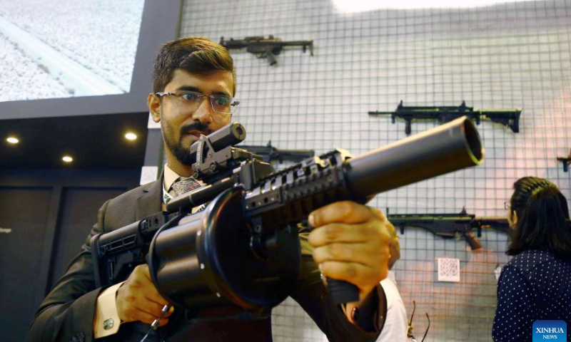 A man checks a gun at the International Defense Exhibition and Seminar (IDEAS) in Karachi, Pakistan on Nov. 16, 2022. The 11th edition of IDEAS is held at the Karachi Expo Center in Pakistan's southern port city of Karachi.  Photo: Xinhua