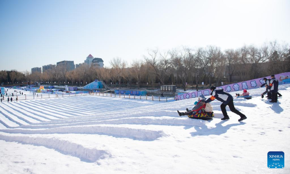 Visitors play on snow slides at an ice and snow carnival at Taoranting park in Beijing, capital of China, Dec 28, 2022. Photo:Xinhua