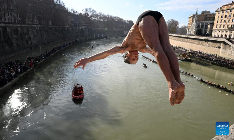 A man dives into the Tiber River from the Ponte Cavour bridge, as a part of traditional New Year celebrations, in Rome, Italy, Jan. 1, 2023. (Photo by Alberto Lingria/Xinhua)