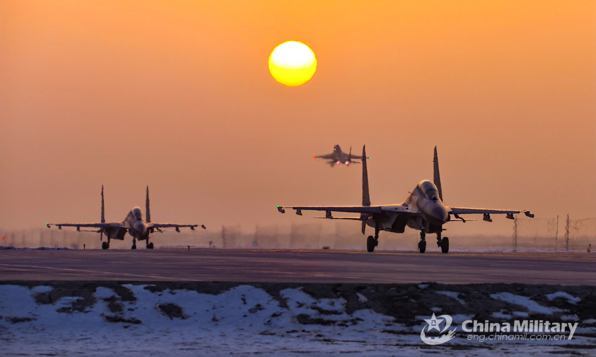 Two fighter jets attached to an aviation brigade of the air force taxi on the runway to get ready for a flight training exercise on December 9, 2022. Photo:China Military