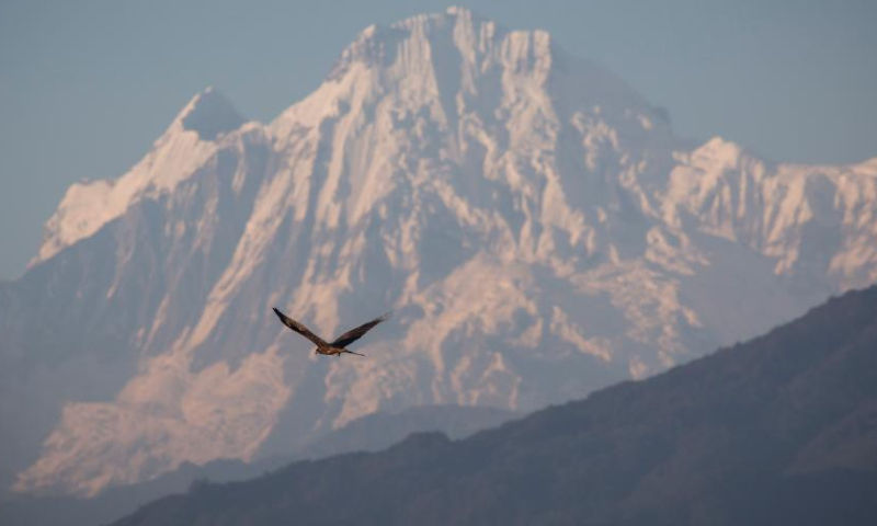 A mountain range is seen from the Kathmandu Valley during the sunset time on the occasion of the International Mountain Day in Lalitpur, Nepal, Dec. 11, 2022. (Photo by Hari Maharjan/Xinhua)