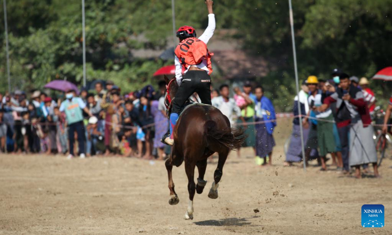 A jockey rides his horse during a horse racing competition in Yangon, Myanmar, Jan. 3, 2023. (Photo by Myo Kyaw Soe/Xinhua)