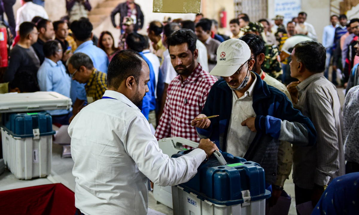 Polling officials collect electronic voting machines, voter verifiable paper audit trail and other election voting materials from a dispatch center a day ahead of the second phase of India’s Gujarat state assembly elections in Ahmedabad, India on December 4, 2022. Photo: AFP