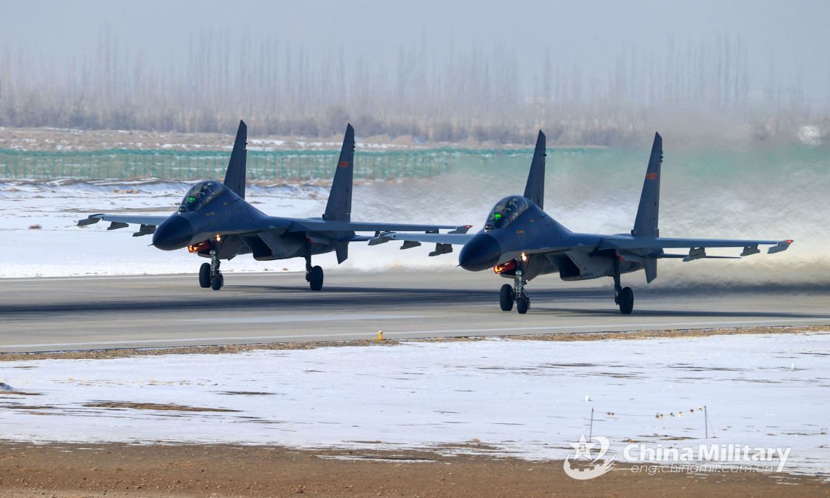 Two fighter jets attached to an aviation brigade of the air force taxi on the runway to get ready for a flight training exercise on December 9, 2022. Photo:China Military