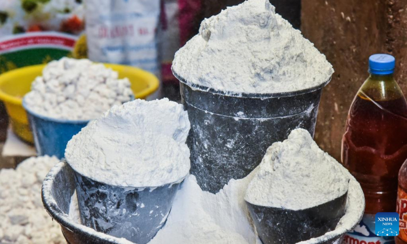 This photo taken on Nov. 21, 2022 shows cassava flour on sale at a market in Yaounde, Cameroon. Cassava, which can be processed into cassava flour or cassava stick, is an important traditional crop in Cameroon. (Photo by Kepseu/Xinhua)