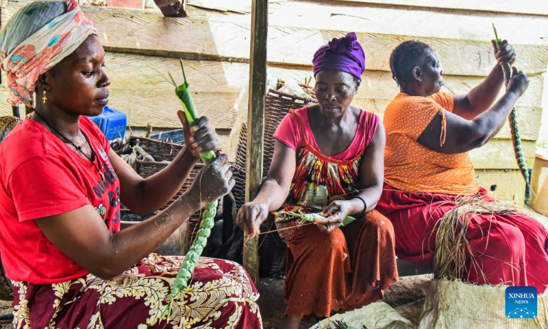 Women make cassava sticks in a village in Mengong town of the South region, Cameroon, Nov. 16, 2022. Cassava, which can be processed into cassava flour or cassava stick, is an important traditional crop in Cameroon. (Photo by Kepseu/Xinhua)