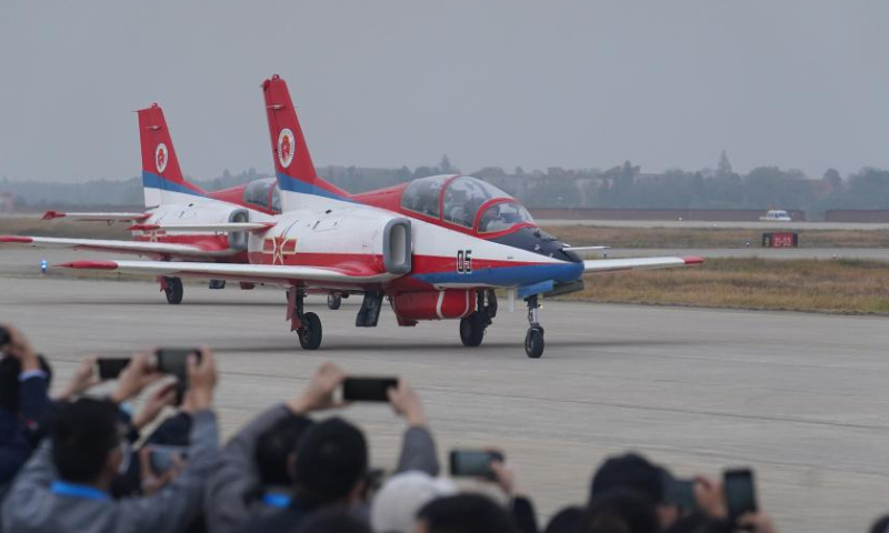 Aircraft from the Hongying aerobatic team taxi past visitors after performing at the Nanchang Air Show in Nanchang, east China's Jiangxi Province, Nov. 25, 2022. The 2022 China Aviation Industry Conference and Nanchang Air Show kicked off here on Friday. (Xinhua/Zhou Mi)