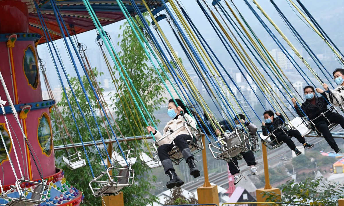 Tourists take a fun ride in an amusement park in Fuling, Southwest China’s Chongqing Municipality on December 8, 2022. Tourism spots in Chongqing gradually resumed operations as the city promoted an orderly recovery from the impact of the epidemic. Photo: cnsphoto