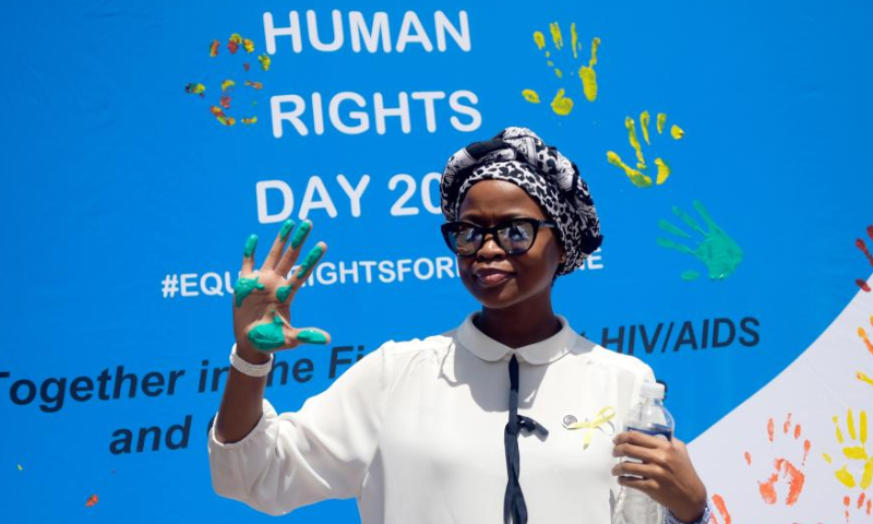 A woman shows her painted hand during a public event to commemorate the Human Rights Day in Gaborone, Botswana on Dec. 9, 2022. Human Rights Day is observed every year on Dec. 10 - the day the United Nations General Assembly adopted in 1948 the Universal Declaration of Human Rights. (Photo by Tshekiso Tebalo/Xinhua)