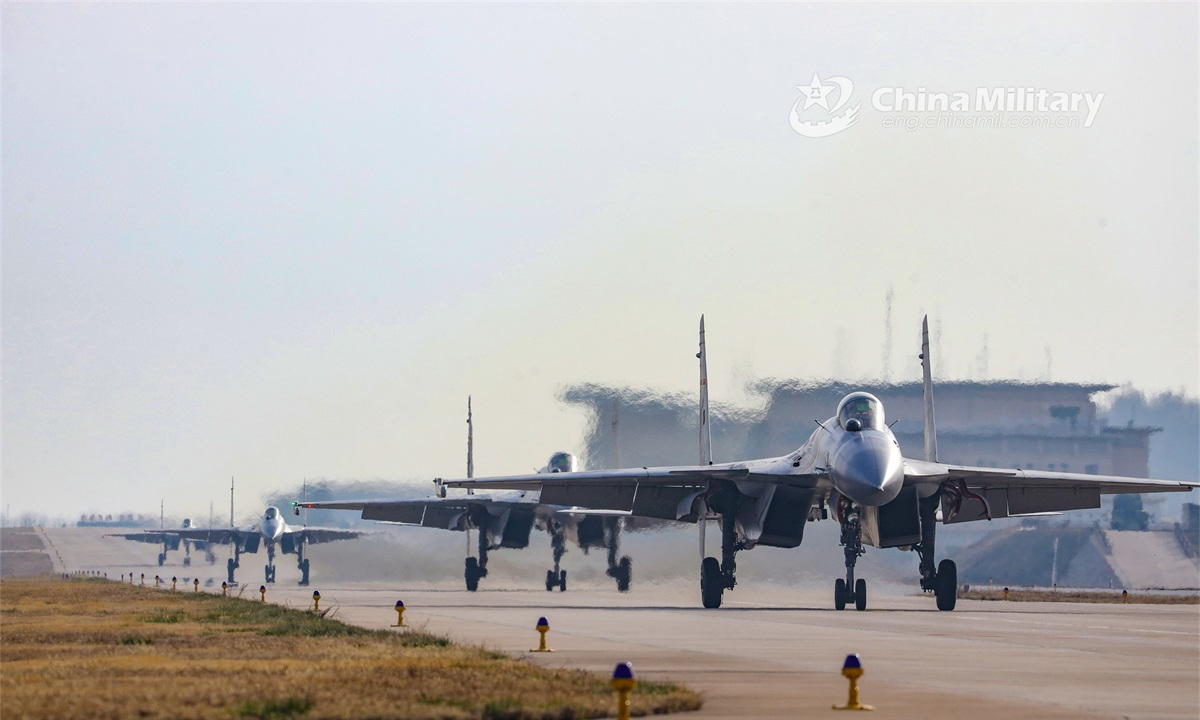 Carrier-based fighter jets attached to a regiment under the PLA Naval Aviation University taxi on the runway before taking off for a real combat flight training exercise on November 16, 2022. (eng.chinamil.com.cn/Photo by Ni Shuai)