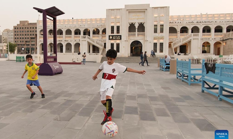 Boys play football at Souq Waqif in Doha, Qatar, on Nov. 8, 2022. (Xinhua/Xu Zijian)