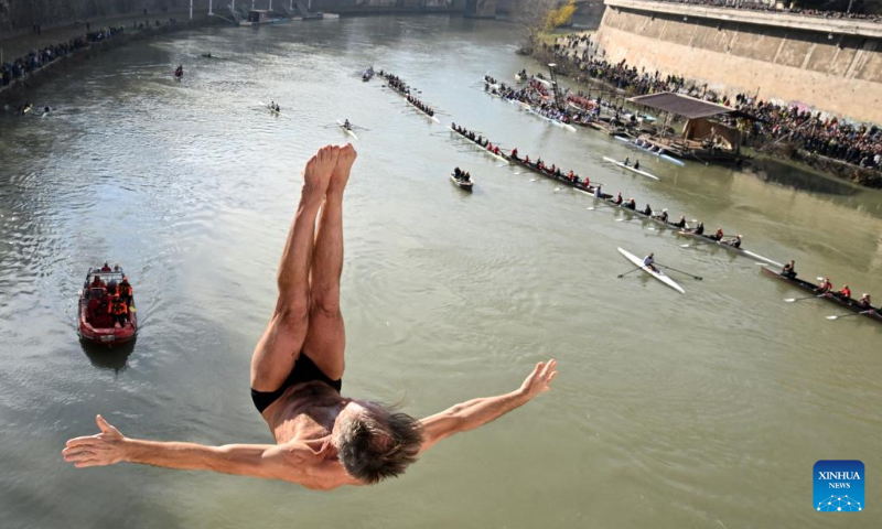 A man dives into the Tiber River from the Ponte Cavour bridge, as a part of traditional New Year celebrations, in Rome, Italy, Jan. 1, 2023. (Photo by Alberto Lingria/Xinhua)