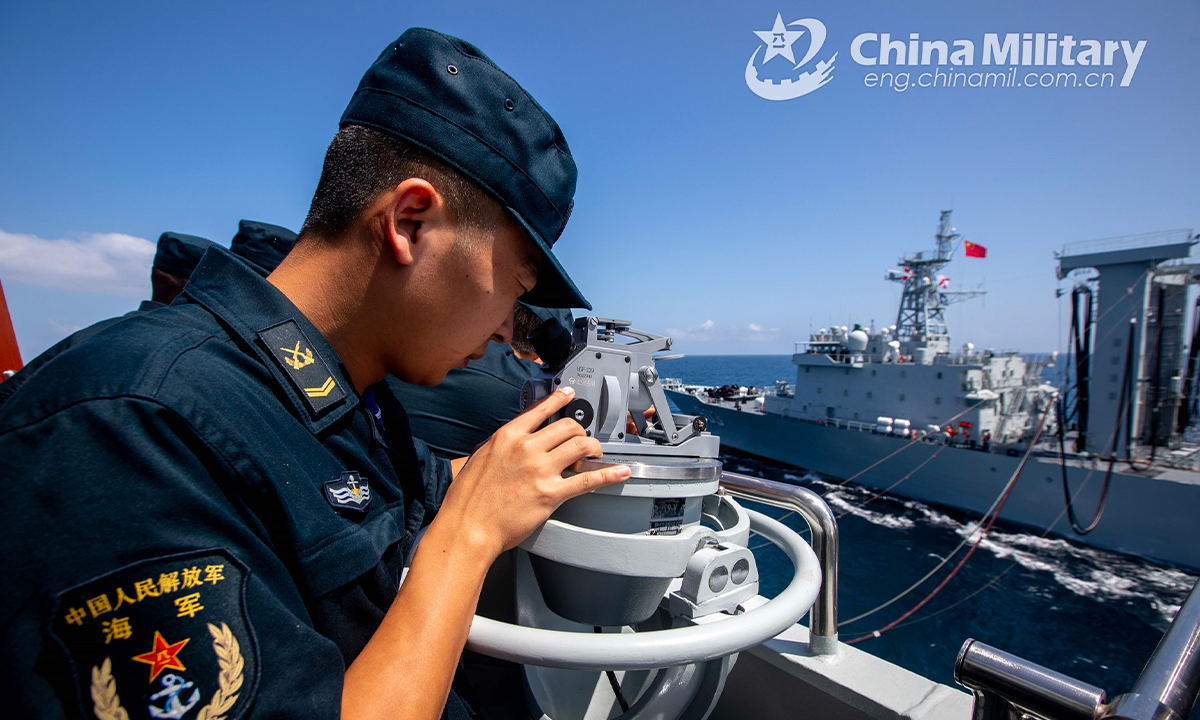 A sailor assigned to the 42nd naval escort taskforce of the Chinese People's Liberation Army (PLA) checks the bearing of the other shipduring a replenishment-at-sea (RAS) in the waters of the Gulf of Aden on October 10, 2022. (eng.chinamil.com.cn/Photo by Wang Qing)