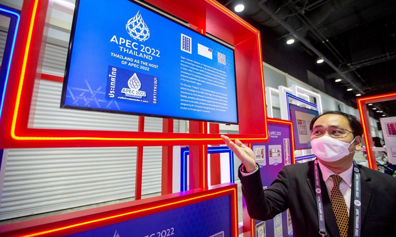 A staff member introduces commemorative stamps of APEC at the Queen Sirikit National Convention Center in Bangkok, Thailand, on Nov. 14, 2022. (Xinhua/Wang Teng)