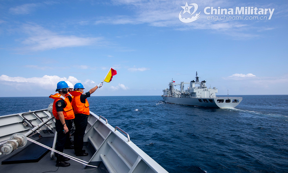 A sailor assigned to the 42nd naval escort taskforce of the Chinese People's Liberation Army (PLA) guides a warship to sail to the designated position for refueling during a replenishment-at-sea (RAS) in the waters of the Gulf of Aden on October 10, 2022. (eng.chinamil.com.cn/Photo by Wang Qing)