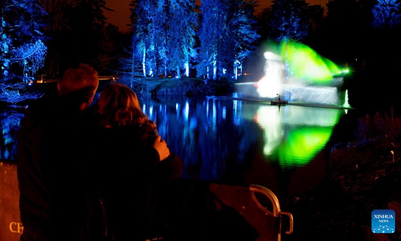 Visitors look at light decorations during the Christmas Garden Berlin light show at the Botanical Garden in Berlin, Germany, Nov. 16, 2022. The Christmas Garden Berlin kicked off on Wednesday here and will last until Jan. 15, 2023. (Photo by Stefan Zeitz/Xinhua)