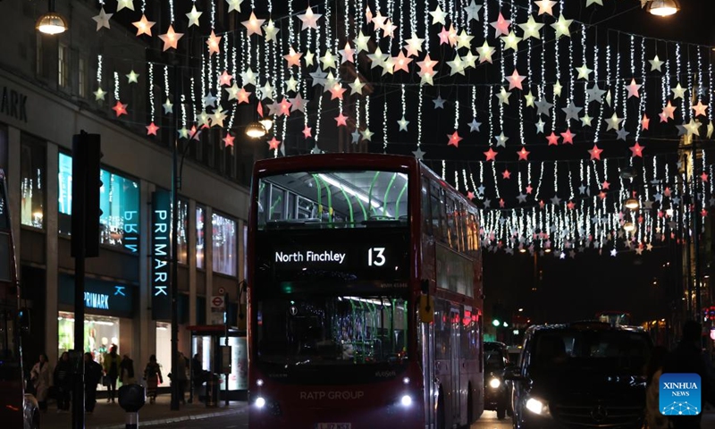 A double-decker bus runs on Oxford Street decorated with Christmas lights in central London, Britain, on Nov. 29, 2022. (Xinhua/Li Ying)