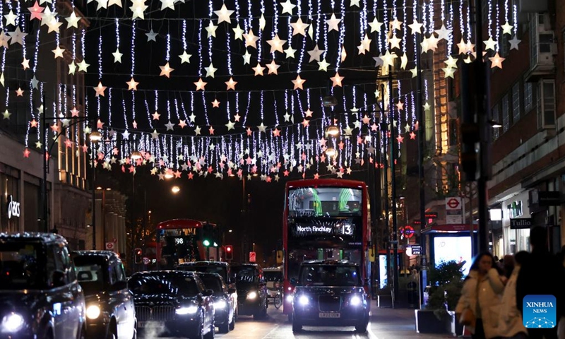 Vehicles run on Oxford Street decorated with Christmas lights in central London, Britain, on Nov. 29, 2022. (Xinhua/Li Ying)