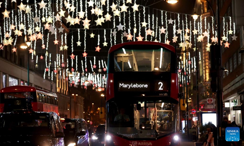 A double-decker bus runs on Oxford Street decorated with Christmas lights in central London, Britain, on Nov. 29, 2022. (Xinhua/Li Ying)