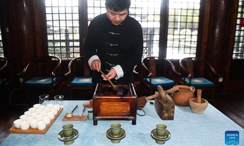 Lin Ruiyang, an inheritor of Zisun tea making techniques, boils tea in a traditional way in Changxing County, east China's Zhejiang Province, Nov. 30, 2022. Zisun tea, produced in the county, has a history of more than 1,000 years. It was designated as the tribute tea in the Tang Dynasty (618-907).(Photo: Xinhua)