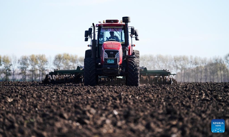 An agricultural machine prepares the field for planting at Xinghua Township, Baiquan County, northeast China's Heilongjiang Province, on Oct. 15, 2022. Dec. 5 marks World Soil Day, a day designated by the UN to highlight the importance of healthy soils and to advocate sustainable management of soil resources.(Photo: Xinhua)