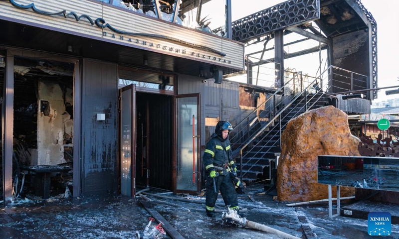 A firefighter is seen outside the burnt down Zuma restaurant in Vladivostok, Russia, on Dec. 7, 2022. The renowned Zuma restaurant was burnt down in a fire on Wednesday.(Photo: Xinhua)