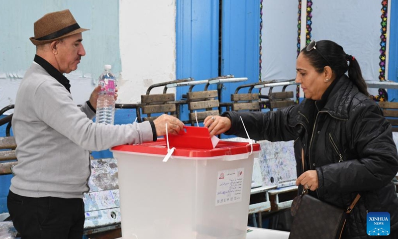 A voter (R) casts vote at a polling station in Tunis, Tunisia on Dec. 17, 2022. Tunisians on Saturday started voting in legislative elections, with a total of 4,551 voting centers and 11,310 polling stations open in the Tunisian territory, the Independent High Authority for Elections (ISIE) said. (Photo by Adel Ezzine/Xinhua)