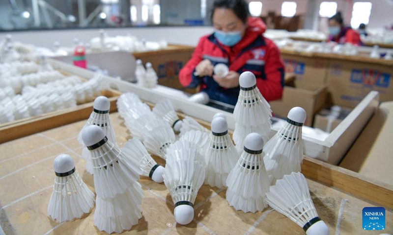 A worker checks products at a badminton shuttlecock enterprise in Jinping County in Qiandongnan Miao and Dong Autonomous Prefecture, southwest China's Guizhou Province, Dec. 19, 2022. In recent years, relying on the excellent natural environment and breeding tradition, Jinping County has comprehensively promoted the goose industry, mainly by introducing badminton shuttlecock production enterprises.(Photo: Xinhua)