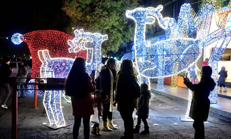 People look at Christmas decorations in Damascus, Syria, on Dec. 22, 2022.(Photo: Xinhua)