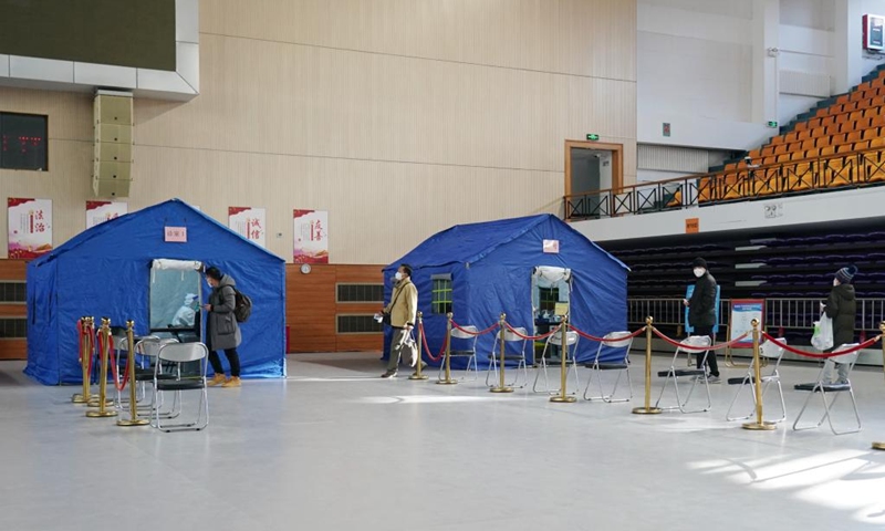 This photo taken on Dec. 24, 2022 shows a makeshift fever clinic in Guang'an Gymnasium in Beijing, capital of China. In order to facilitate fever patients to seek medical treatment and ensure residents' medical needs, some hospitals in Beijing set up makeshift fever clinics in gymnasiums to provide services such as diagnosis, prescription issuing and medicine dispensing for citizens. (Xinhua/Zhang Chenlin)