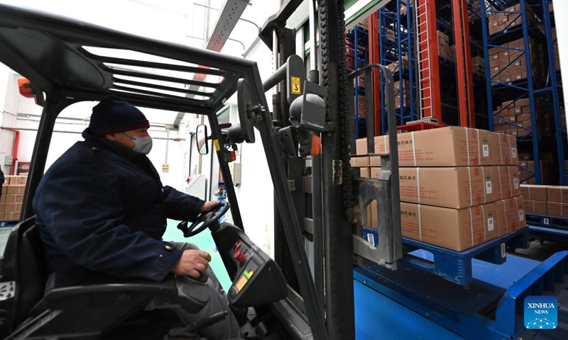 A worker transfers medicine at a pharmaceutical company in north China's Tianjin, Dec. 24, 2022. Pharmaceutical production lines in Tianjin are running at full capacity, increasing the market supply of medicine for COVID-19 symptoms. (Xinhua/Zhao Zishuo)