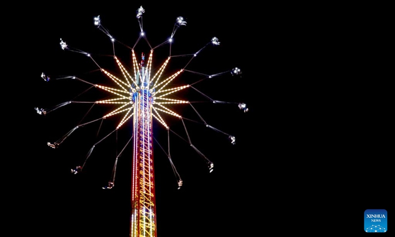 A carnival ride spin is seen at Hyde Park Winter Wonderland on Christmas Eve in London, Britain, Dec. 24, 2022. (Xinhua/Li Ying)