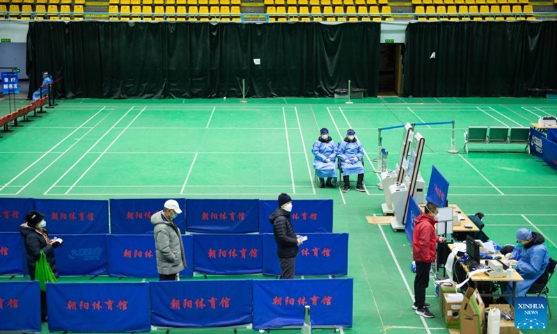 This photo taken on Dec. 24, 2022 shows a makeshift fever clinic of Beijing Chaoyang Hospital in Chaoyang Gymnasium in Beijing, capital of China. In order to facilitate fever patients to seek medical treatment and ensure residents' medical needs, some hospitals in Beijing set up makeshift fever clinics in gymnasiums to provide services such as diagnosis, prescription issuing and medicine dispensing for citizens. (Xinhua/Chen Zhonghao)