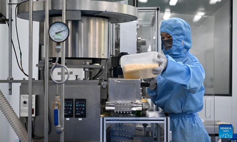 A worker works at a pharmaceutical company in north China's Tianjin, Dec. 24, 2022. Pharmaceutical production lines in Tianjin are running at full capacity, increasing the market supply of medicine for COVID-19 symptoms. (Xinhua/Zhao Zishuo)