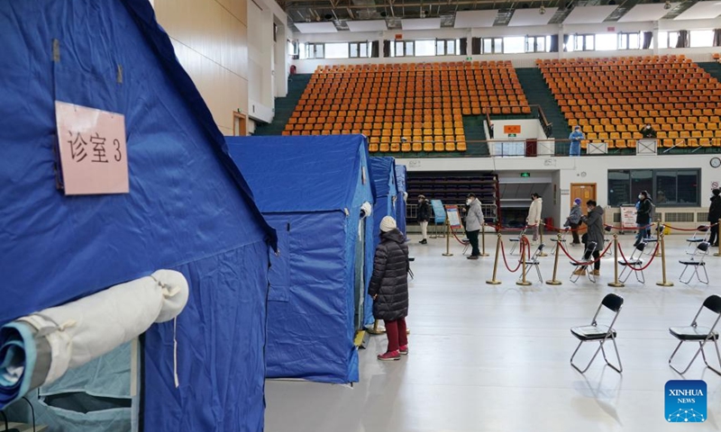 This photo taken on Dec. 24, 2022 shows a makeshift fever clinic in Guang'an Gymnasium in Beijing, capital of China. In order to facilitate fever patients to seek medical treatment and ensure residents' medical needs, some hospitals in Beijing set up makeshift fever clinics in gymnasiums to provide services such as diagnosis, prescription issuing and medicine dispensing for citizens. (Xinhua/Zhang Chenlin)