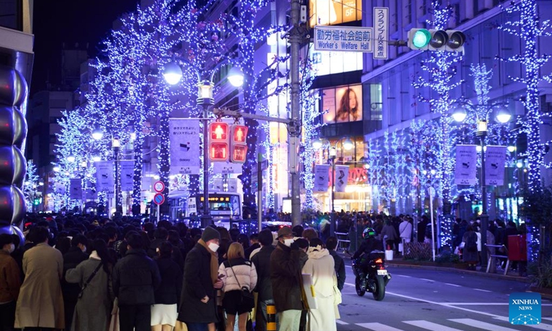 People walk along a street with Christmas lights in Shibuya, Tokyo, Japan, Dec. 25, 2022. (Xinhua/Zhang Xiaoyu)