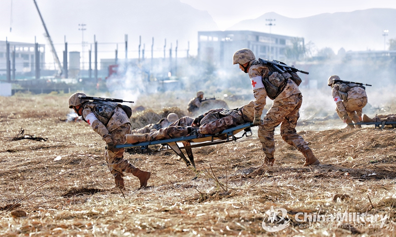 Medics assigned to a combined-arms brigade with the army under the PLA Central Theater Command transfer the wounded from the battlefield with stretchers during a real combat medical support training exercise on November 28, 2022. (eng.chinamil.com.cn/Photo by Yan Qizhao)