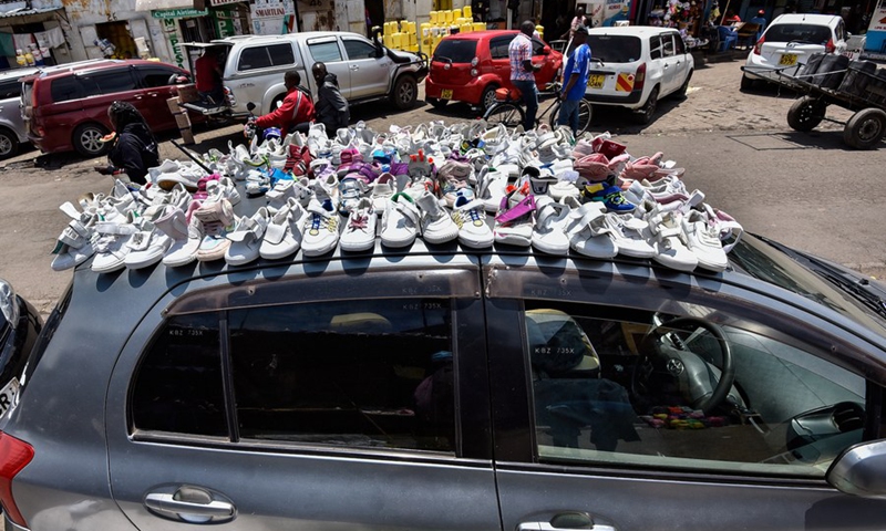 A trader displays second-hand shoes for sale in Nakuru County, Kenya, on Sept. 1, 2022. (Photo by Sheikh Maina/Xinhua)