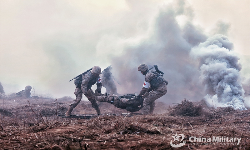 Medics assigned to a combined-arms brigade with the army under the PLA Central Theater Command transfer the wounded from the battlefield with stretchers during a real combat medical support training exercise on November 28, 2022. (eng.chinamil.com.cn/Photo by Yan Qizhao)